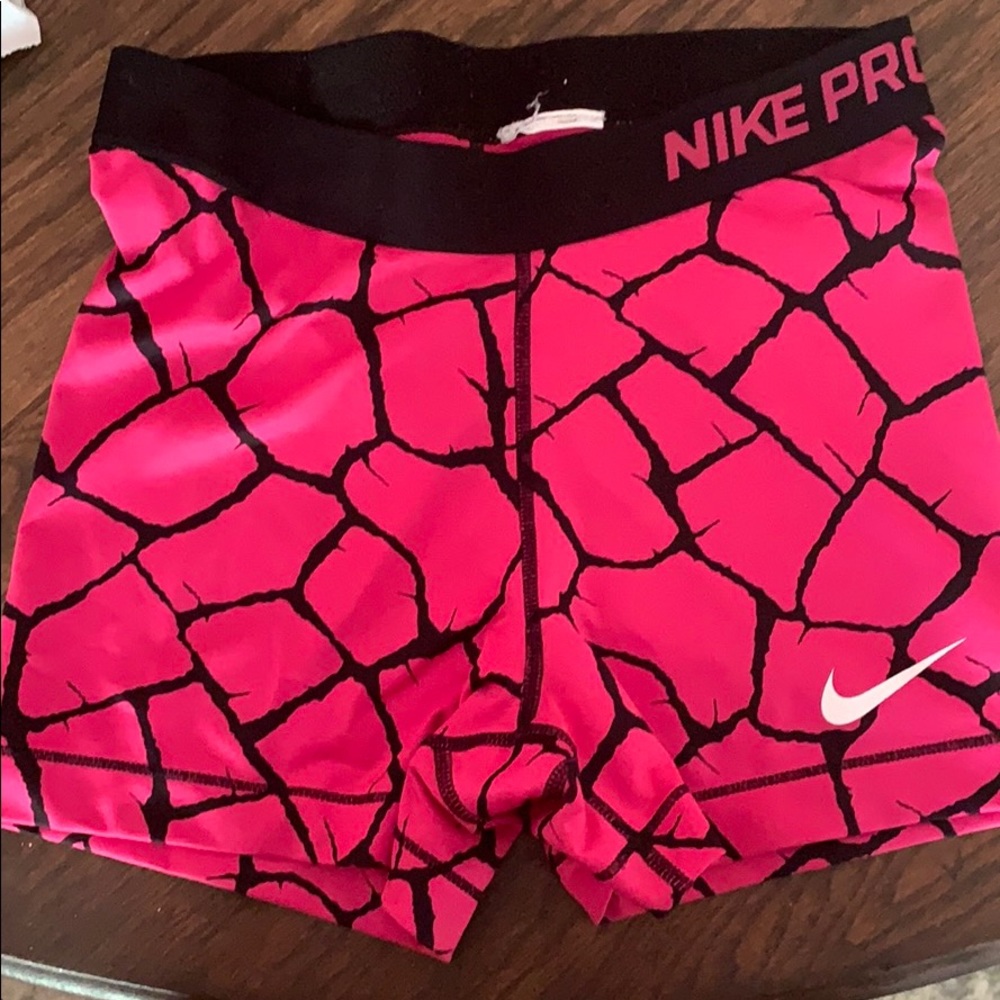 Black and pink size medium Nike pro shorts.